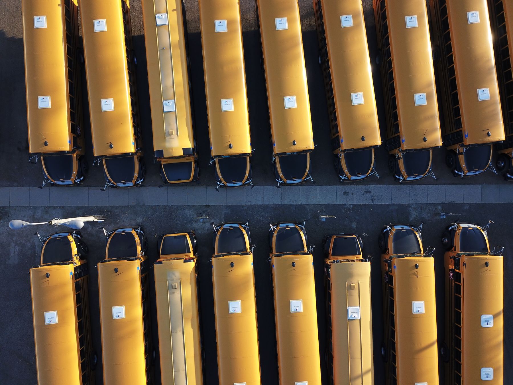 Aerial view of yellow school buses neatly parked in rows