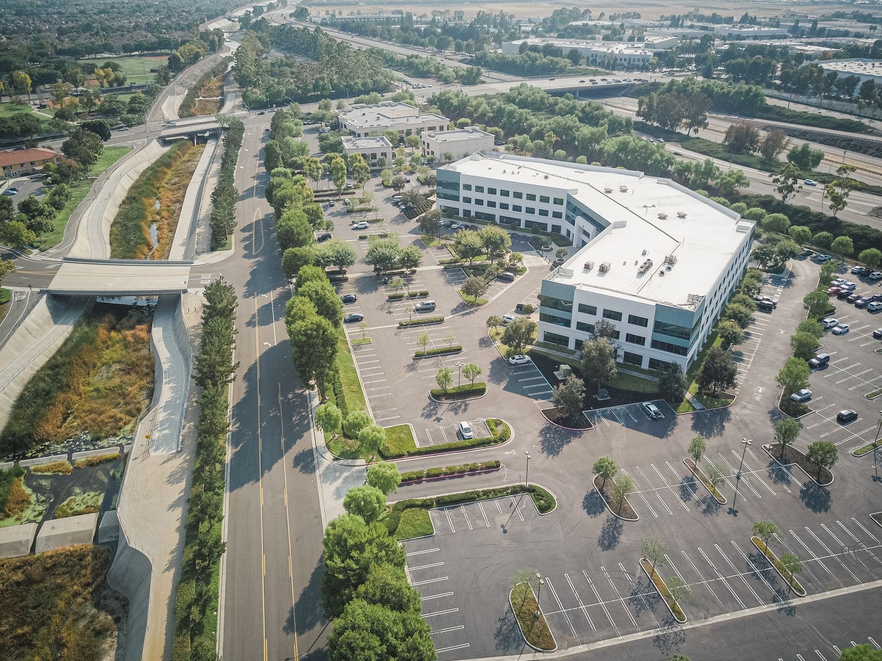 Aerial view of a low-rise suburban office park with parking lots and landscaping