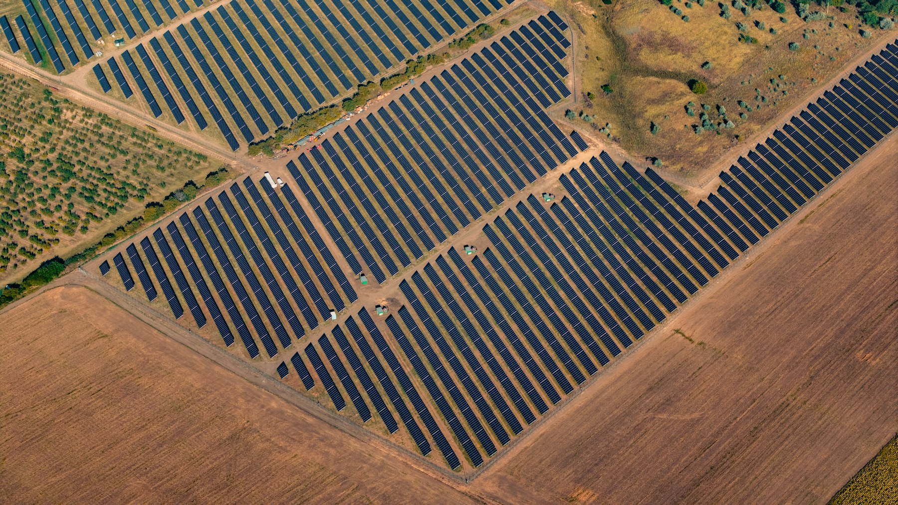 Aerial view of a large ground-mounted solar panel farm