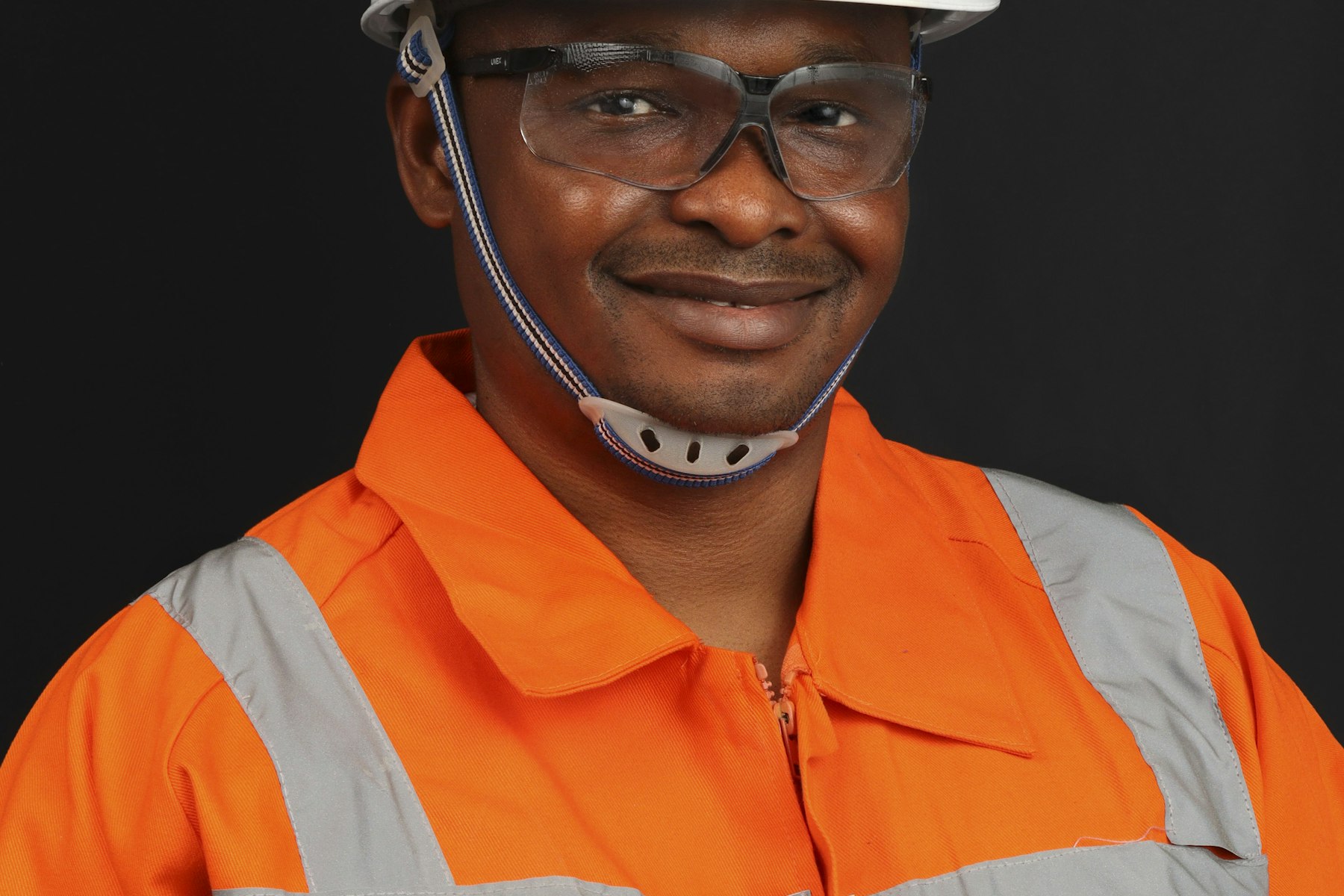 Worker wearing a hard hat and safety gear on a job site